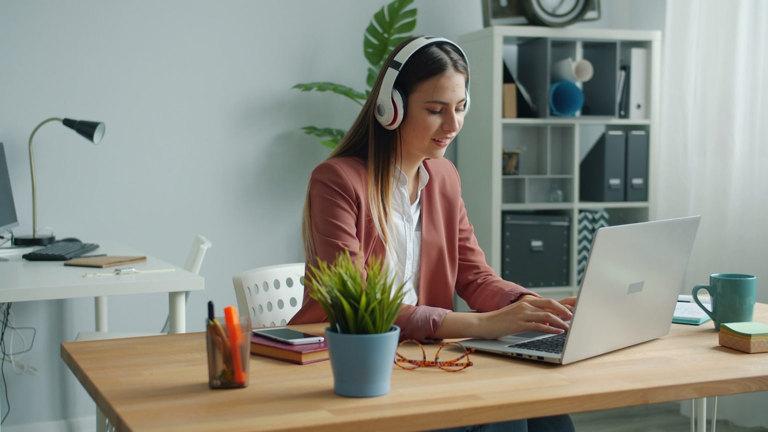 Postazione di lavoro in Home Office con cuffie e notebook